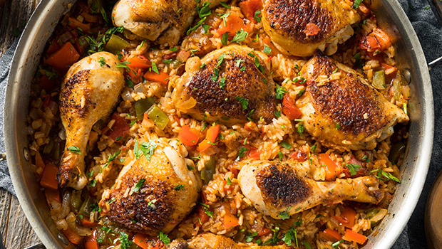 Spanish-style rice with chicken legs and thighs in a large pot