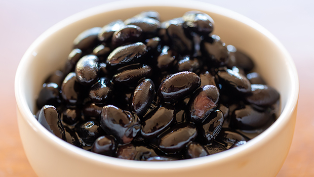 Cooked black beans in a small white bowl