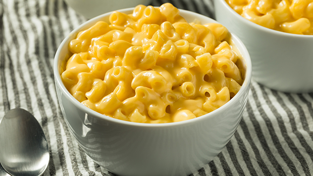 Two bowls of macaroni and cheese with one bowl closer in view