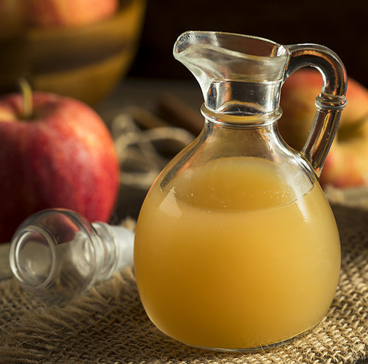 Apple vinaigrette dressing in a small glass pitcher