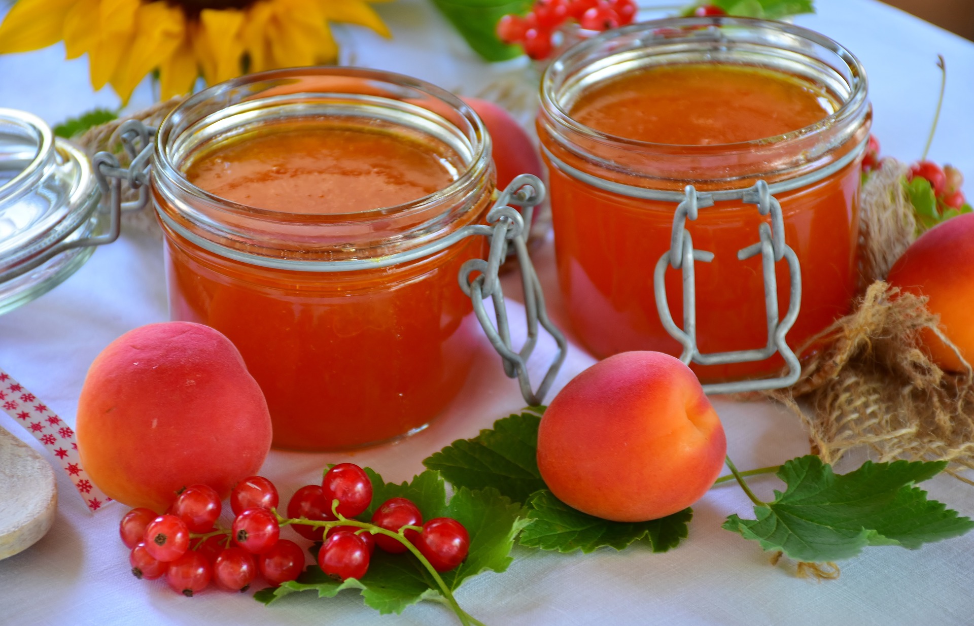 Two clear jars filled with apricot jelly