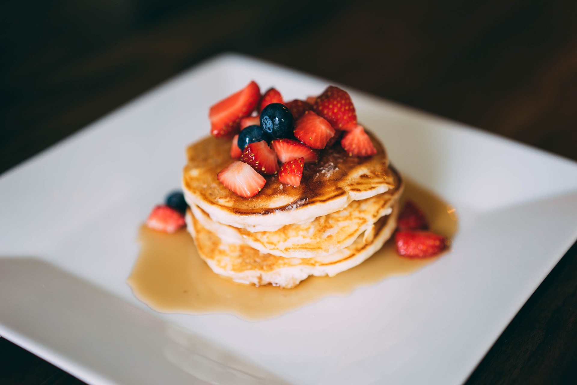 Pancake stack with fruit and syrup