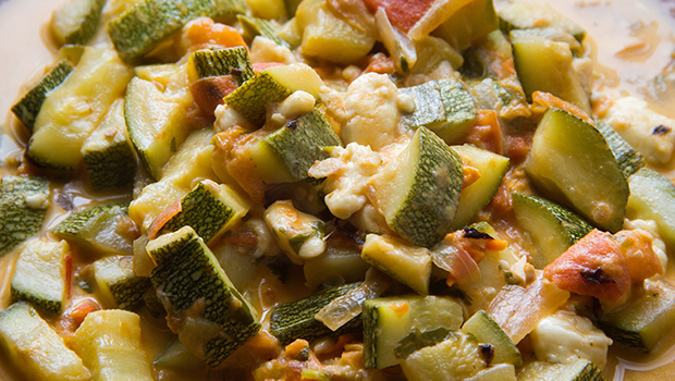 Close-up of cooked zucchini with tomatoes and onions