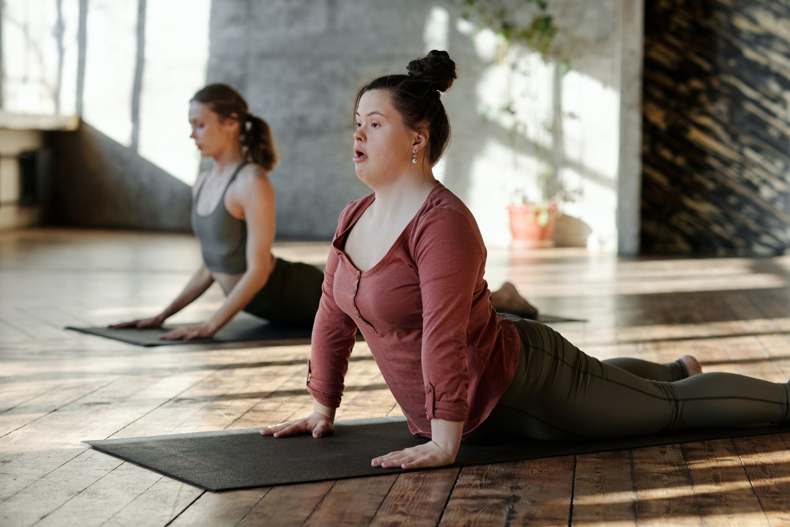 two women doing the cobra yoga pose
